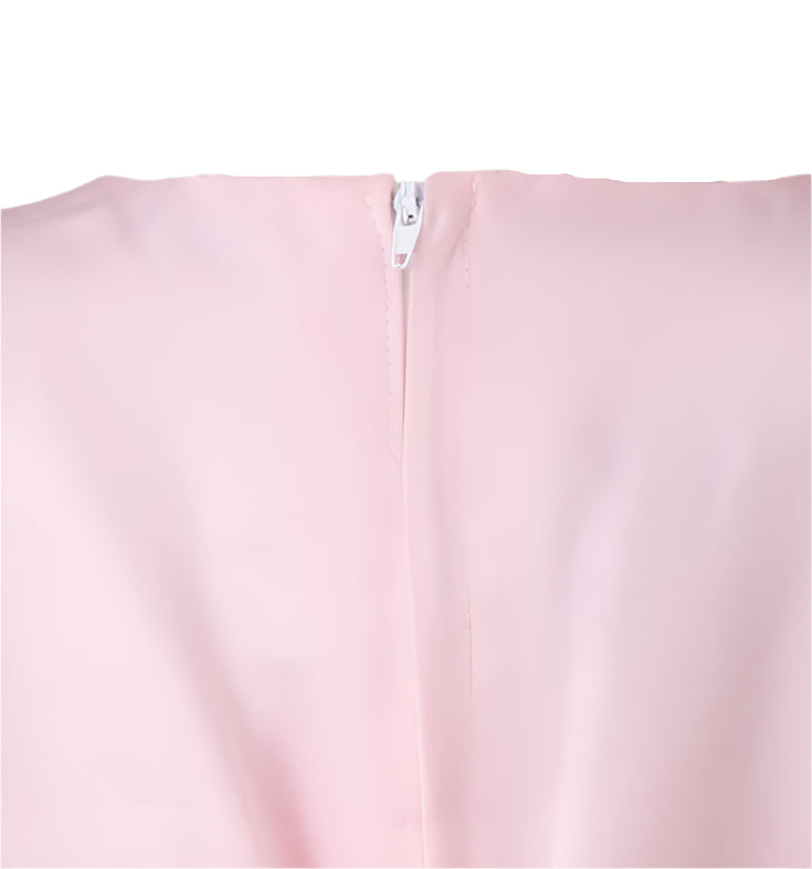 Close-up of a pink garment with a zipper on a mannequin against a gray background
