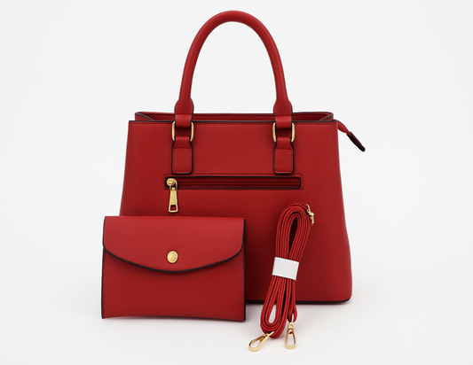 Red handbag with matching wallet and strap on a white background