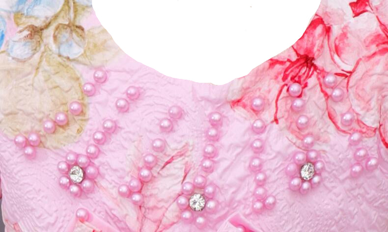 Close-up of a pink embroidered garment with pearls and floral patterns