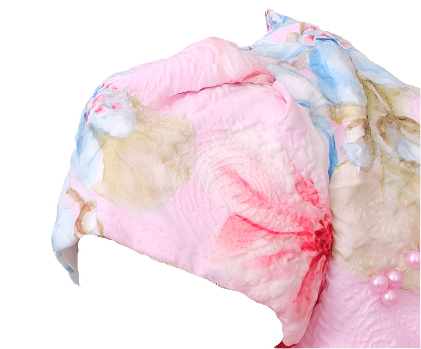 Colorful floral-patterned headscarf on a mannequin head against a gray background
